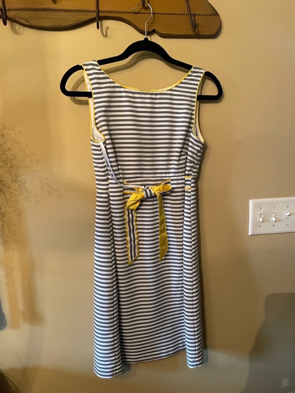 Sleeveless lined  Dress with Yellow trim and gray and white stripes.